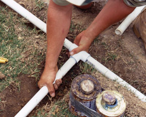 Oceanside sprinkler repair technician replaces PVC pipes